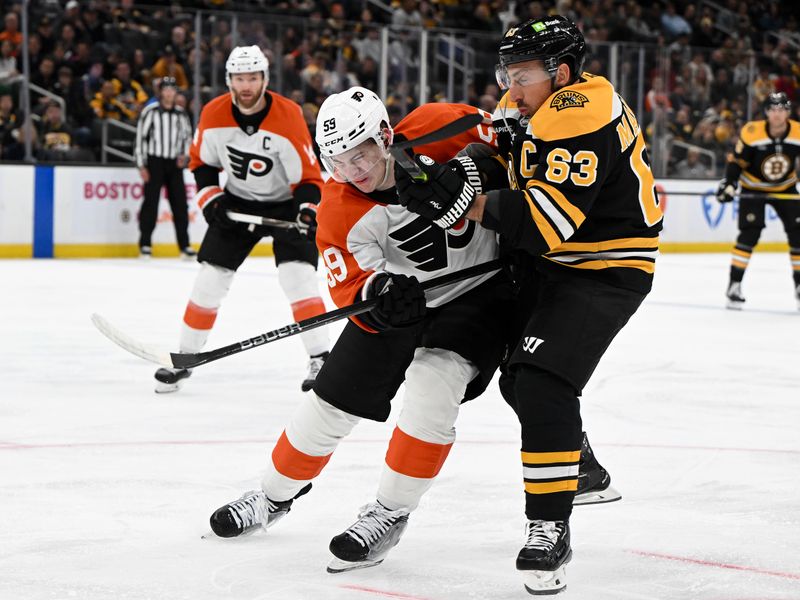 Oct 1, 2024; Boston, Massachusetts, USA; Boston Bruins left wing Brad Marchand (63) and Philadelphia Flyers defenseman Oliver Bonk (59) battle for the puck during the first period at the TD Garden. Mandatory Credit: Brian Fluharty-Imagn Images