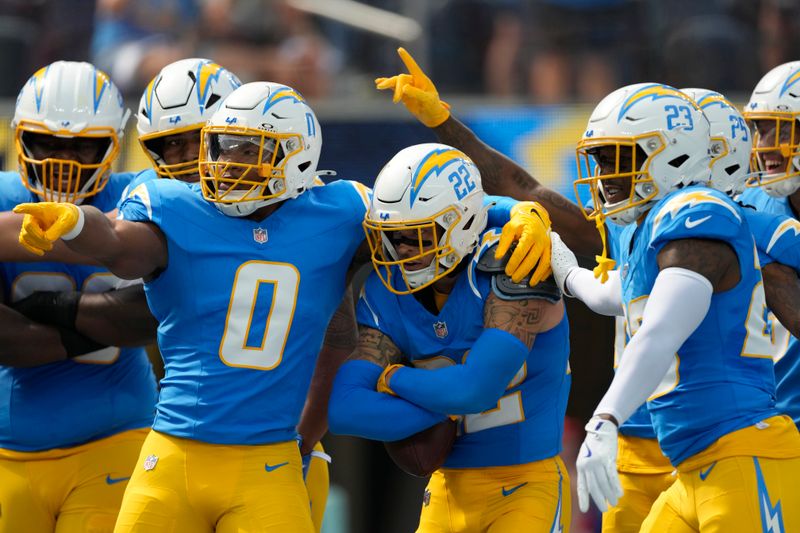 Los Angeles Chargers defensive back Elijah Molden (22) is congratulated by teammates after recovering a fumble during the first half of an NFL football game against the Kansas City Chiefs Sunday, Sept. 29, 2024, in Inglewood, Calif. (AP Photo/Ashley Landis)