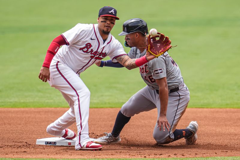 Jun 19, 2024; Cumberland, Georgia, USA; Detroit Tigers right fielder Wenceel Perez (46) steals second base behind Atlanta Braves shortstop Orlando Arcia (11) during the first inning  at Truist Park. Mandatory Credit: Dale Zanine-USA TODAY Sports