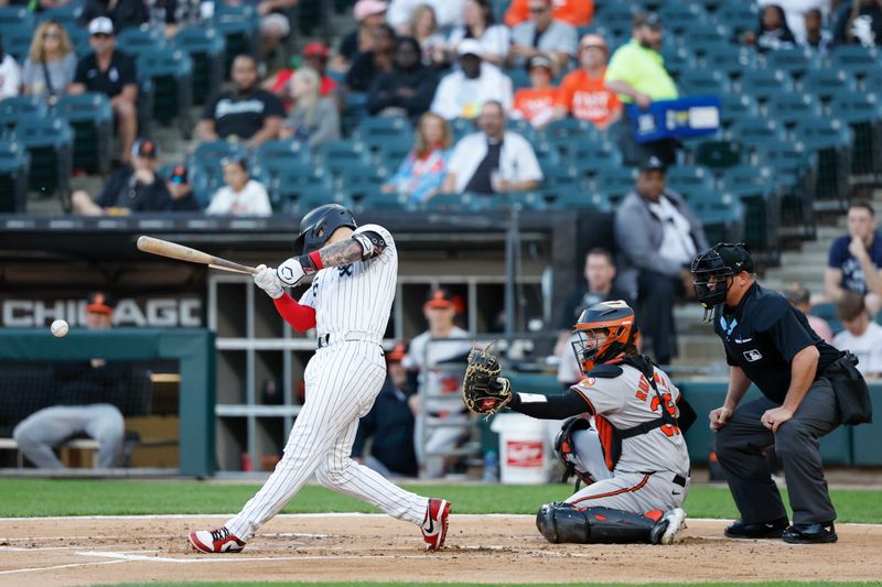 May 23, 2024; Chicago, Illinois, USA; Chicago White Sox catcher Korey Lee (26) breaks his bat against the Baltimore Orioles during the first inning at Guaranteed Rate Field. Mandatory Credit: Kamil Krzaczynski-USA TODAY Sports