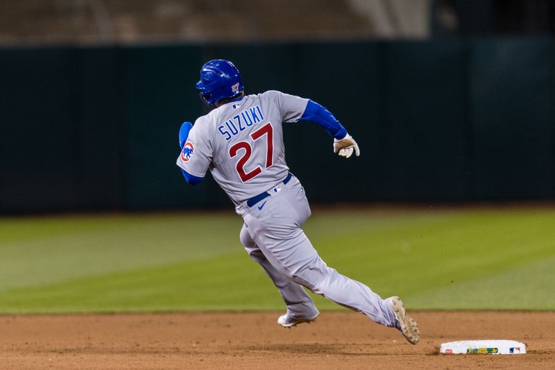 Apr 18, 2023; Oakland, California, USA; Chicago Cubs right fielder Seiya Suzuki (27) rounds second base against the Oakland Athletics during the eighth inning at RingCentral Coliseum. Mandatory Credit: John Hefti-USA TODAY Sports