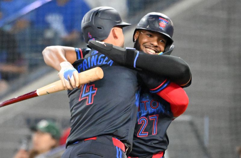May 30, 2025; Toronto, Ontario, CAN;  Toronto Blue Jays first baseman Vladimir Guerrero Jr. (27) greets designated hitter George Springer (4) after they both scored runs against the Athletics in the fifth inning at Rogers Centre. Mandatory Credit: Dan Hamilton-Imagn Images