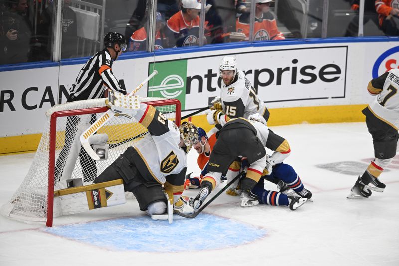 May 12, 2025; Edmonton, Alberta, CAN; Vegas Golden Knights goalie Adin Hill (33) with center William Karlsson (71) and Knights defenseman Noah Hanfin (15) battle for the puck with Edmonton Oilers left winger Zach Hyman (18)  during the second period in game three of the second round of the 2025 Stanley Cup Playoffs at Rogers Place. Mandatory Credit: Walter Tychnowicz-Imagn Images