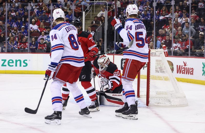 Sep 30, 2024; Newark, New Jersey, USA; New Jersey Devils goaltender Jeremy Brodeur (60) makes a save against the New York Rangers during the first period at Prudential Center. Mandatory Credit: Ed Mulholland-Imagn Images