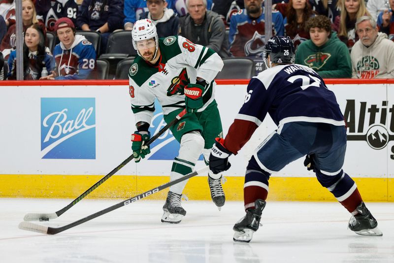 Mar 8, 2024; Denver, Colorado, USA; Minnesota Wild center Frederick Gaudreau (89) controls the puck as Colorado Avalanche defenseman Sean Walker (26) defends in the first period at Ball Arena. Mandatory Credit: Isaiah J. Downing-USA TODAY Sports