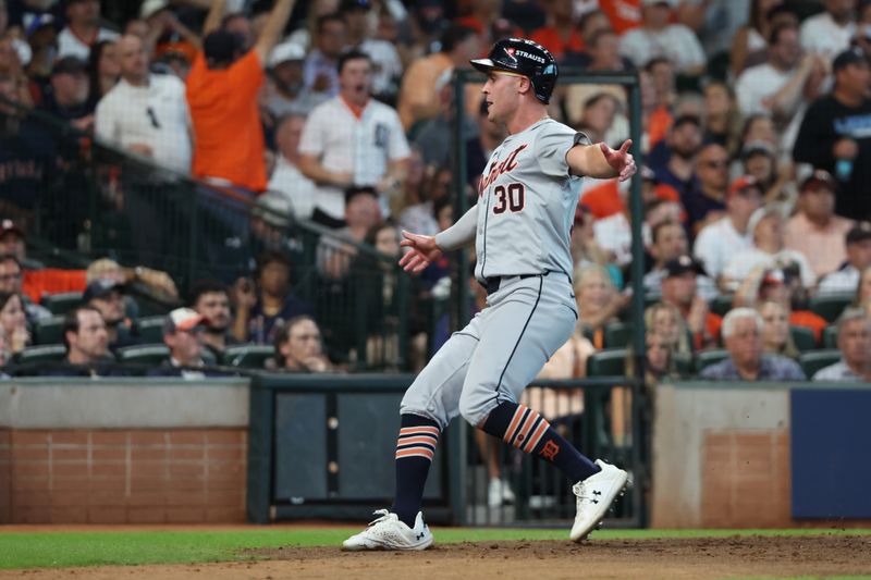 Oct 2, 2024; Houston, Texas, USA; Detroit Tigers outfielder Kerry Carpenter (30) scores a run against the Houston Astros during the eighth inning of game two of the Wildcard round for the 2024 MLB Playoffs at Minute Maid Park. Mandatory Credit: Thomas Shea-Imagn Images