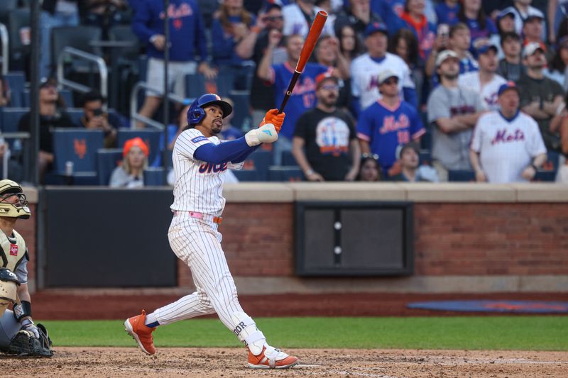 May 26, 2025; New York City, New York, USA; New York Mets shortstop Francisco Lindor (12) hits a game winning sacrifice fly during the ninth inning against the Chicago White Sox at Citi Field. Mandatory Credit: Vincent Carchietta-Imagn Images