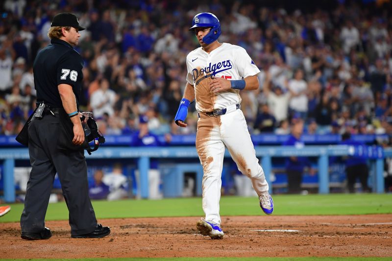 Aug 29, 2024; Los Angeles, California, USA;  Los Angeles Dodgers catcher Austin Barnes (15) scores a run against the Baltimore Orioles during the fourth inning at Dodger Stadium. Mandatory Credit: Gary A. Vasquez-USA TODAY Sports