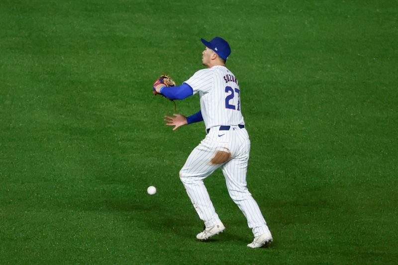 Jun 1, 2024; Chicago, Illinois, USA; Chicago Cubs outfielder Seiya Suzuki (27) is unable to catch a ball hit by Cincinnati Reds catcher Luke Maile during the second inning at Wrigley Field. Mandatory Credit: Kamil Krzaczynski-USA TODAY Sports