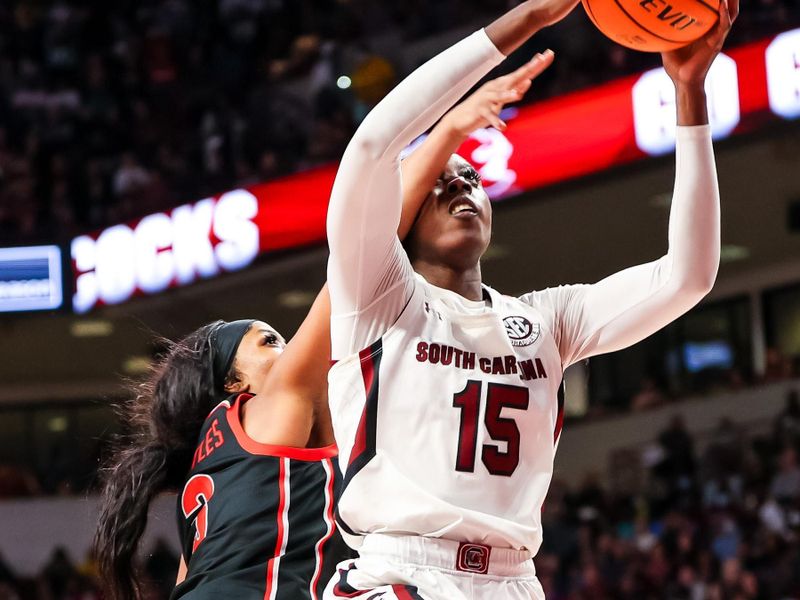 Feb 26, 2023; Columbia, South Carolina, USA; South Carolina Gamecocks forward Laeticia Amihere (15) is fouled by Georgia Lady Bulldogs guard Diamond Battles (3) in the second half at Colonial Life Arena. Mandatory Credit: Jeff Blake-USA TODAY Sports