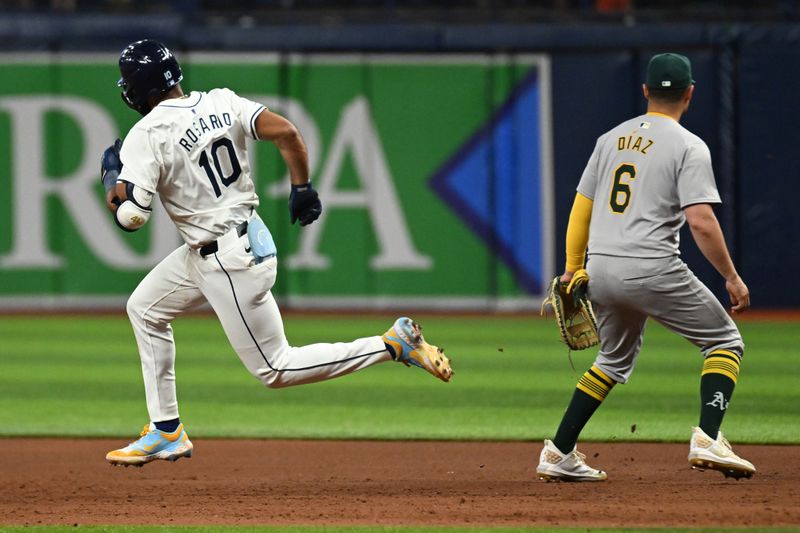 May 29, 2024; St. Petersburg, Florida, USA; Tampa Bay Rays shortstop Amed Rosario (10) hits a double in the ninth inning against the Oakland Athletics  at Tropicana Field. Mandatory Credit: Jonathan Dyer-USA TODAY Sports