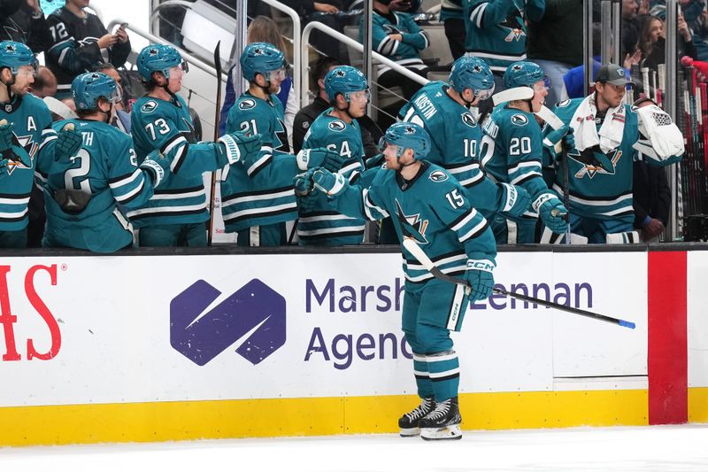 Jan 4, 2025; San Jose, California, USA; San Jose Sharks right wing Nikolai Kovalenko (15) celebrates with teammates after scoring a goal against the New Jersey Devils during the first period at SAP Center at San Jose. Mandatory Credit: Darren Yamashita-Imagn Images