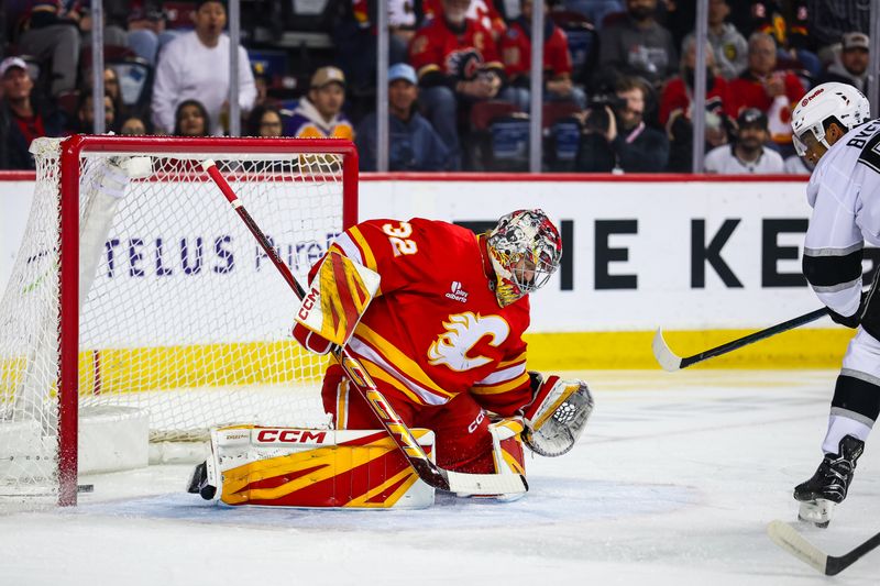 Mar 24, 2026; Calgary, Alberta, CAN; Los Angeles Kings right wing Quinton Byfield (55) scores a goal against Calgary Flames goaltender Dustin Wolf (32) during the first period at Scotiabank Saddledome. Mandatory Credit: Sergei Belski-Imagn Images