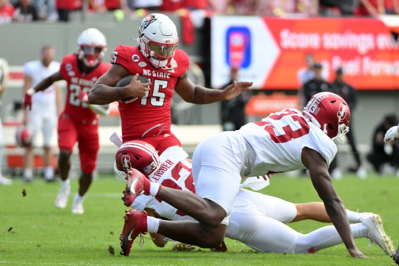 Nov 2, 2024; Raleigh, North Carolina, USA;  North Carolina State Wolfpack corner back Tamarcus Cooley (15) is tackled by Stanford Cardinals saftey Mitch Leigber (32) during the first quarter against Stanford Cardinals at Carter-Finley Stadium. Mandatory Credit: Zachary Taft-Imagn Images