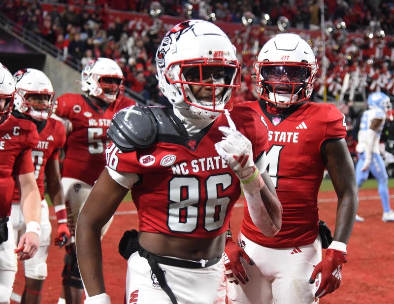 Nov 25, 2023; Raleigh, North Carolina, USA; North Carolina State Wolfpack receiver Dacari Collins (86) reacts after scoring a two-point conversion against the North Carolina Tar Heels during the second half at Carter-Finley Stadium. Mandatory Credit: Rob Kinnan-USA TODAY Sports