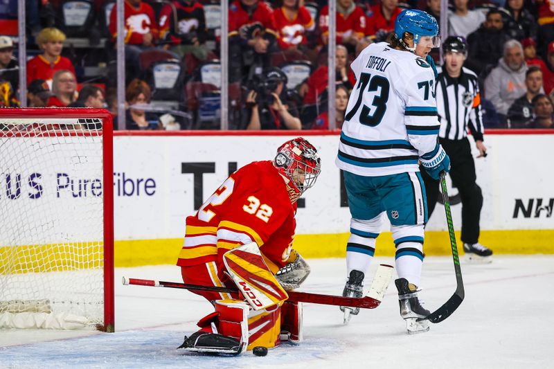 Apr 13, 2025; Calgary, Alberta, CAN; Calgary Flames goaltender Dustin Wolf (32) makes a save against the San Jose Sharks during the third period at Scotiabank Saddledome. Mandatory Credit: Sergei Belski-Imagn Images