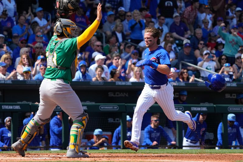 Mar 14, 2024; Mesa, Arizona, USA; Chicago Cubs second baseman Nico Hoerner (2) scores a run against the Oakland Athletics in the first inning at Sloan Park. Mandatory Credit: Rick Scuteri-USA TODAY Sports