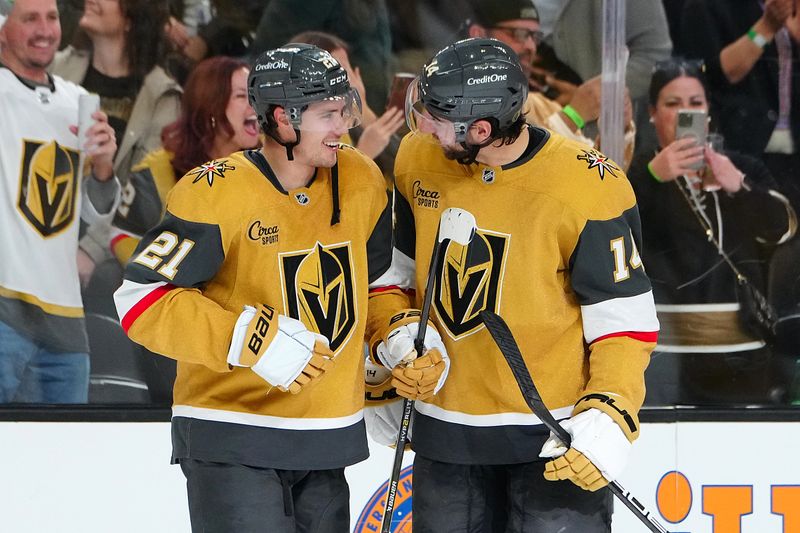 Nov 2, 2024; Las Vegas, Nevada, USA; Vegas Golden Knights center Brett Howden (21) celebrates with  defenseman Nicolas Hague (14) after scoring a goal against the Utah Hockey Club in overtime to give the Golden Knights a 4-3 win at T-Mobile Arena. Mandatory Credit: Stephen R. Sylvanie-Imagn Images