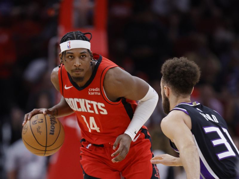 HOUSTON, TEXAS - NOVEMBER 06: Nate Hinton #14 of the Houston Rockets controls the ball ahead of Jordan Ford #31 of the Sacramento Kings during the second half at Toyota Center on November 06, 2023 in Houston, Texas. (Photo by Carmen Mandato/Getty Images)