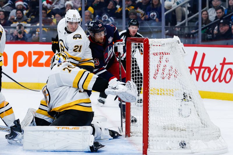 Dec 11, 2025; Winnipeg, Manitoba, CAN; Winnipeg Jets forward Gabriel Vilardi (13) scores onf Boston Bruins goalie Joonas Jorpisalo (70) during the second period at Canada Life Centre.  Mandatory Credit: Terrence Lee-Imagn Images