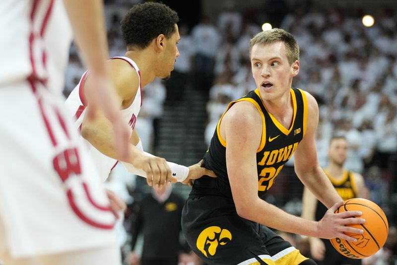 Feb 22, 2023; Madison, Wisconsin, USA; Iowa Hawkeyes forward Payton Sandfort (20) looks to pass the ball against Wisconsin Badgers guard Jordan Davis (2) during the first half at the Kohl Center. Mandatory Credit: Kayla Wolf-USA TODAY Sports