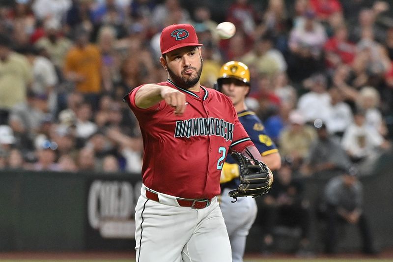 Apr 11, 2025; Phoenix, Arizona, USA; Arizona Diamondbacks third base Eugenio Suárez (28) throws to first base in the fourth inning against the Milwaukee Brewers at Chase Field. Mandatory Credit: Matt Kartozian-Imagn Images