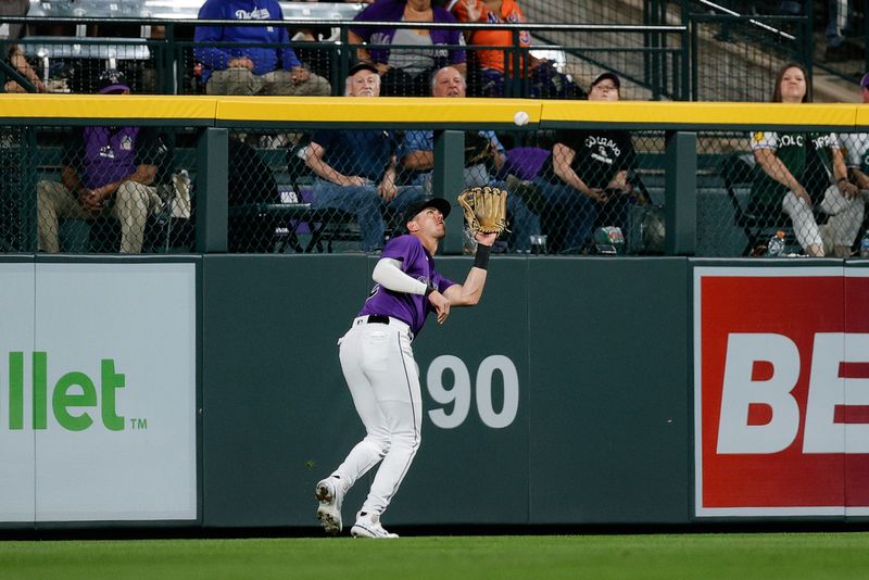 Sep 26, 2023; Denver, Colorado, USA; Colorado Rockies left fielder Nolan Jones (22) makes a catch for an out in the sixth inning against the Los Angeles Dodgers at Coors Field. Mandatory Credit: Isaiah J. Downing-USA TODAY Sports