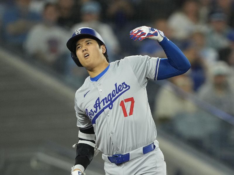 Apr 28, 2024; Toronto, Ontario, CAN; Los Angeles Dodgers designated hitter Shohei Ohtani (17) reacts after taking a pitch off his hands on a strike by the Toronto Blue Jays during the sixth inning at Rogers Centre. Mandatory Credit: John E. Sokolowski-USA TODAY Sports