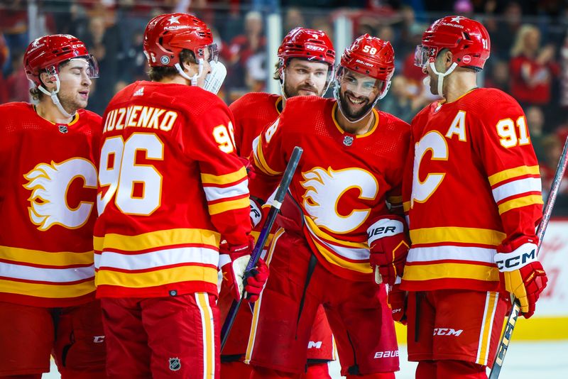 Apr 18, 2024; Calgary, Alberta, CAN; Calgary Flames defenseman Oliver Kylington (58) celebrates his goal with teammates against the San Jose Sharks during the second period at Scotiabank Saddledome. Mandatory Credit: Sergei Belski-USA TODAY Sports