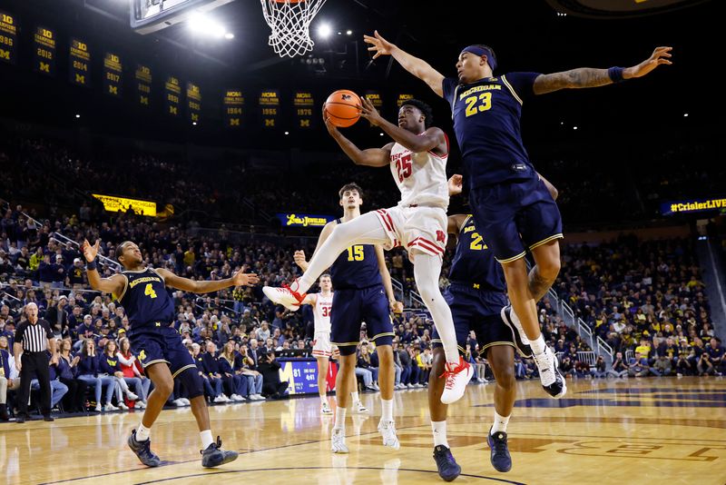Jan 10, 2026; Ann Arbor, Michigan, USA;  Wisconsin Badgers guard John Blackwell (25) shoots on Michigan Wolverines forward Yaxel Lendeborg (23) in the second half at Crisler Center. Mandatory Credit: Rick Osentoski-Imagn Images