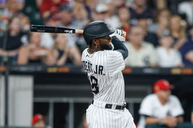 Jul 4, 2023; Chicago, Illinois, USA; Chicago White Sox center fielder Luis Robert Jr. (88) hits a three-run home run against the Toronto Blue Jays during the sixth inning at Guaranteed Rate Field. Mandatory Credit: Kamil Krzaczynski-USA TODAY Sports