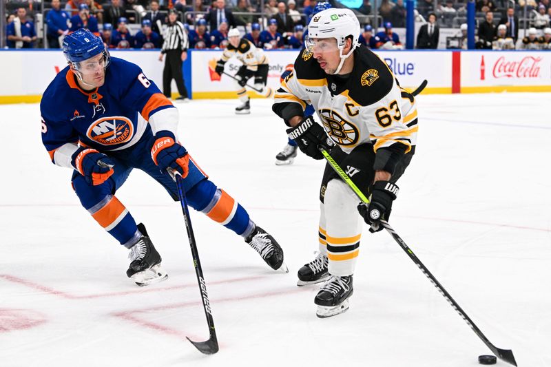 Nov 27, 2024; Elmont, New York, USA;  New York Islanders defenseman Ryan Pulock (6) defends against Boston Bruins left wing Brad Marchand (63) during the first period at UBS Arena. Mandatory Credit: Dennis Schneidler-Imagn Images