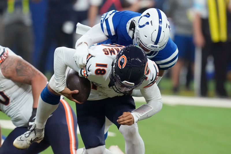 Chicago Bears quarterback Caleb Williams (18) is sacked by Indianapolis Colts defensive tackle Taven Bryan (96) during the first half of an NFL football game Sunday, Sept. 22, 2024, in Indianapolis. (AP Photo/Darron Cummings)