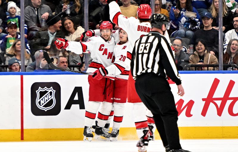 Dec 30, 2023; Toronto, Ontario, CAN; Carolina Hurricanes forward Michael Bunting (58) celebrates after scoring a goal against the Toronto Maple Leafs in the first period at Scotiabank Arena. Mandatory Credit: Dan Hamilton-USA TODAY Sports