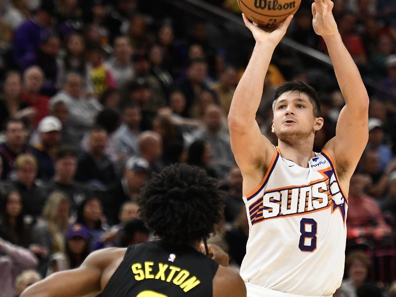 SALT LAKE CITY, UTAH - NOVEMBER 19: Grayson Allen #8 of the Phoenix Suns shoots the ball against Collin Sexton #2 of the Utah Jazz during the second half of a game at Delta Center on November 19, 2023 in Salt Lake City, Utah. NOTE TO USER: User expressly acknowledges and agrees that, by downloading and or using this photograph, User is consenting to the terms and conditions of the Getty Images License Agreement. (Photo by Alex Goodlett/Getty Images)