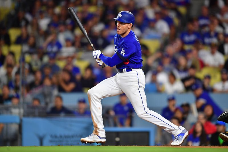 Jul 6, 2023; Los Angeles, California, USA; Los Angeles Dodgers first baseman Freddie Freeman (5) hits a n RBI single against the Pittsburgh Pirates during the seventh inning at Dodger Stadium. Mandatory Credit: Gary A. Vasquez-USA TODAY Sports