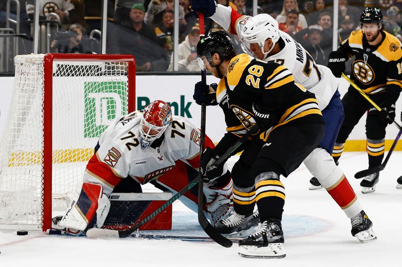 Oct 14, 2024; Boston, Massachusetts, USA; Florida Panthers defenseman Niko Mikkola (77) holds back Boston Bruins center Elias Lindholm (28) from getting to a loose puck at the side of the net of Florida Panthers goaltender Sergei Bobrovsky (72) during the second period at TD Garden. Mandatory Credit: Winslow Townson-Imagn Images