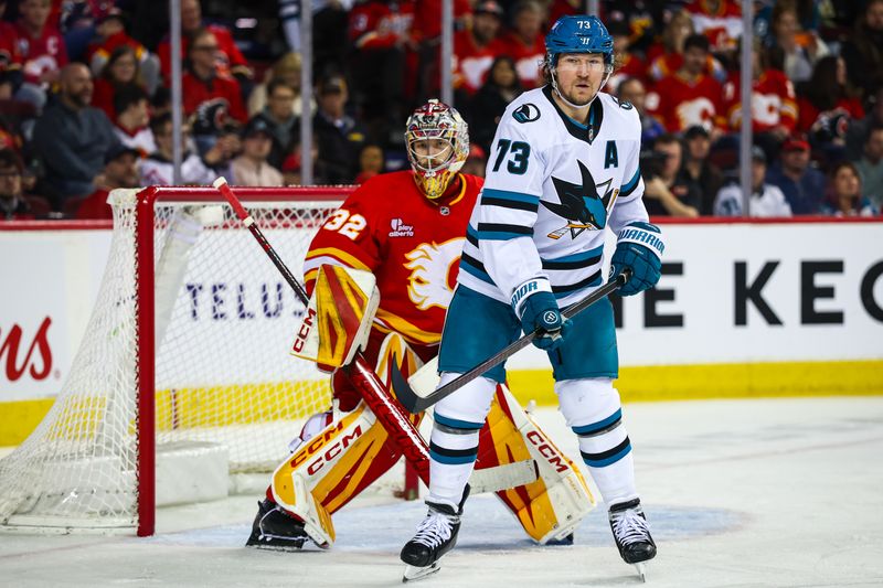 Jan 31, 2026; Calgary, Alberta, CAN; San Jose Sharks center Tyler Toffoli (73) screens in front of Calgary Flames goaltender Dustin Wolf (32) during the third period at Scotiabank Saddledome. Mandatory Credit: Sergei Belski-Imagn Images