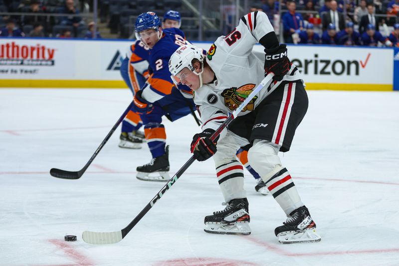 Apr 2, 2024; Elmont, New York, USA; Chicago Blackhawks right wing MacKenzie Entwistle (58) moves the puck against the New York Islanders during the third period at UBS Arena. Mandatory Credit: Thomas Salus-USA TODAY Sports