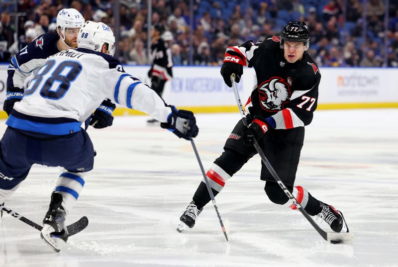 Mar 3, 2024; Buffalo, New York, USA;  Winnipeg Jets defenseman Nate Schmidt (88) tries to block a shot by Buffalo Sabres right wing JJ Peterka (77) during the second period at KeyBank Center. Mandatory Credit: Timothy T. Ludwig-USA TODAY Sports