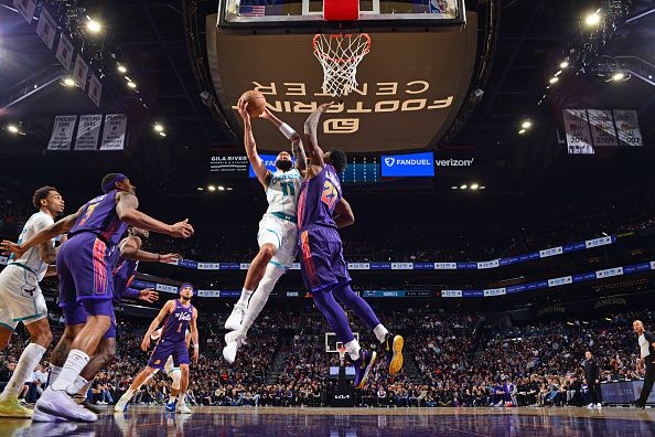 PHOENIX, AZ - DECEMBER 29: Cody Martin #11 of the Charlotte Hornets drives to the basket during the game against the Phoenix Suns on December 29 2023 at Footprint Center in Phoenix, Arizona. NOTE TO USER: User expressly acknowledges and agrees that, by downloading and or using this photograph, user is consenting to the terms and conditions of the Getty Images License Agreement. Mandatory Copyright Notice: Copyright 2023 NBAE (Photo by Barry Gossage/NBAE via Getty Images)