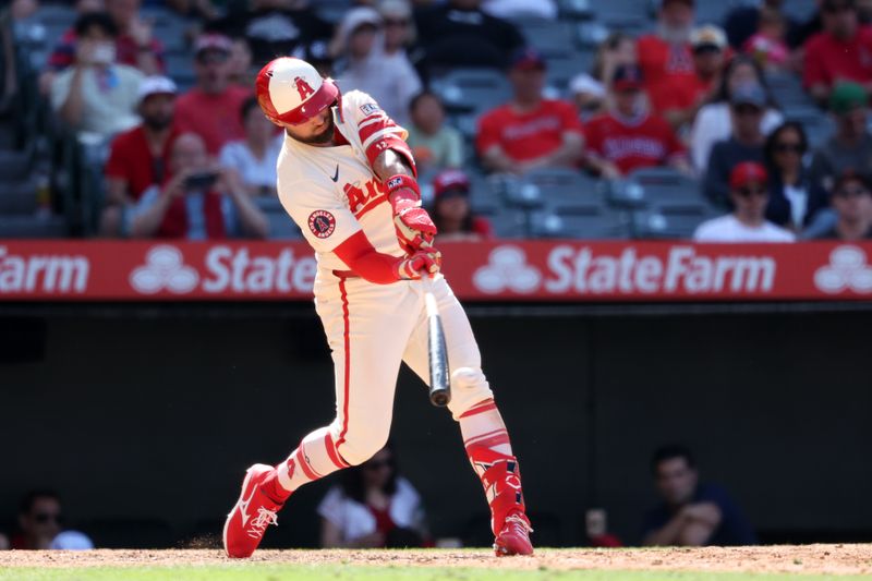 Jun 9, 2024; Anaheim, California, USA;  Los Angeles Angels right fielder Kevin Pillar (12) hits a single during the ninth inning against the Houston Astros at Angel Stadium. Mandatory Credit: Kiyoshi Mio-USA TODAY Sports