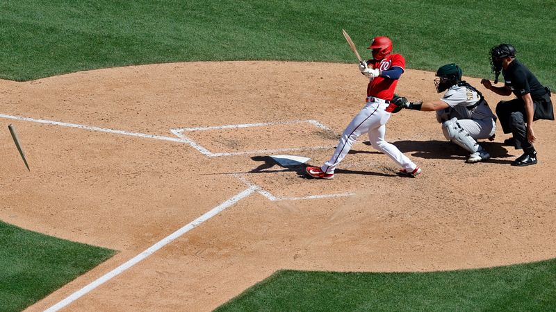 Aug 13, 2023; Washington, District of Columbia, USA; Washington Nationals left fielder Stone Garrett (36) breaks his bat on a sacrifice fly against the Oakland Athletics during the seventh inning at Nationals Park. Mandatory Credit: Geoff Burke-USA TODAY Sports