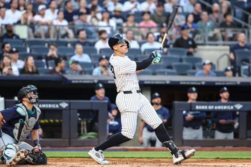 May 22, 2024; Bronx, New York, USA;  New York Yankees center fielder Aaron Judge (99) hits a two run home run in the first inning against the Seattle Mariners at Yankee Stadium. Mandatory Credit: Wendell Cruz-USA TODAY Sports