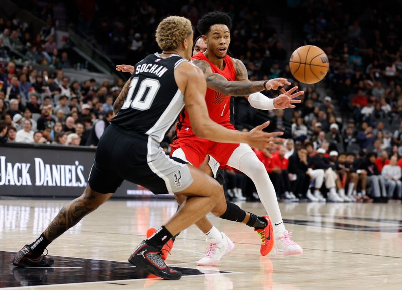 SAN ANTONIO, TX - JANUARY  26: Anfernee Simons #1 of the Portland Trail Blazers  passes by Jeremy Sochan #10 of the San Antonio Spurs in the second half at Frost Bank Center on January 26, 2024 in San Antonio, Texas. NOTE TO USER: User expressly acknowledges and agrees that, by downloading and or using this photograph, User is consenting to terms and conditions of the Getty Images License Agreement. (Photo by Ronald Cortes/Getty Images)