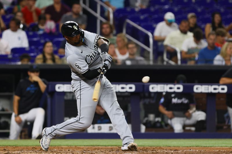 Jul 5, 2024; Miami, Florida, USA; Chicago White Sox catcher Martin Maldonado (15) hits an RBI double against the Miami Marlins during the fourth inning at loanDepot Park. Mandatory Credit: Sam Navarro-USA TODAY Sports