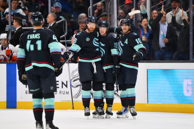 Nov 16, 2024; Seattle, Washington, USA; The Seattle Kraken celebrate after a goal scored by left wing Jared McCann (19) during the third period against the New York Islanders at Climate Pledge Arena. Mandatory Credit: Steven Bisig-Imagn Images