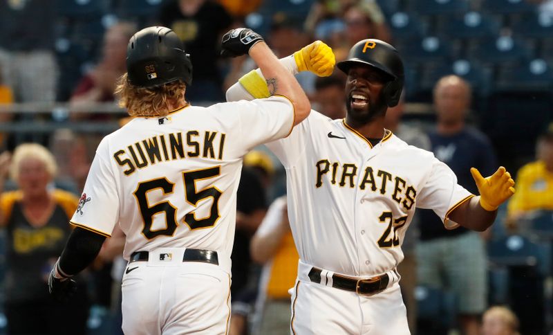 Sep 4, 2023; Pittsburgh, Pennsylvania, USA;  Pittsburgh Pirates designated hitter Andrew McCutchen (22) greets center fielder Jack Suwinski (65) after crossing home plate on a two-run home run against the Milwaukee Brewers during the fourth inning at PNC Park. Mandatory Credit: Charles LeClaire-USA TODAY Sports