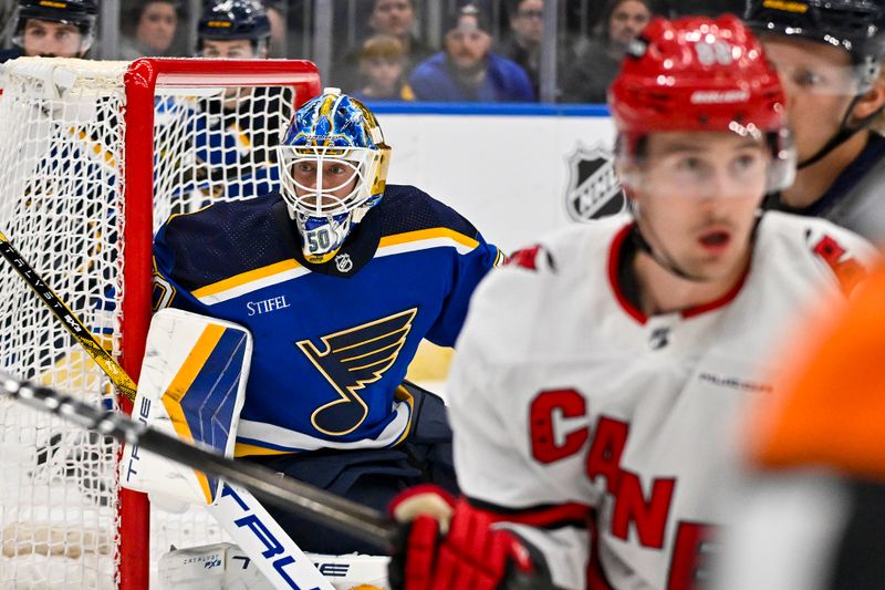 Apr 12, 2024; St. Louis, Missouri, USA;  St. Louis Blues goaltender Jordan Binnington (50) defends the net against the Carolina Hurricanes during the first period at Enterprise Center. Mandatory Credit: Jeff Curry-USA TODAY Sports