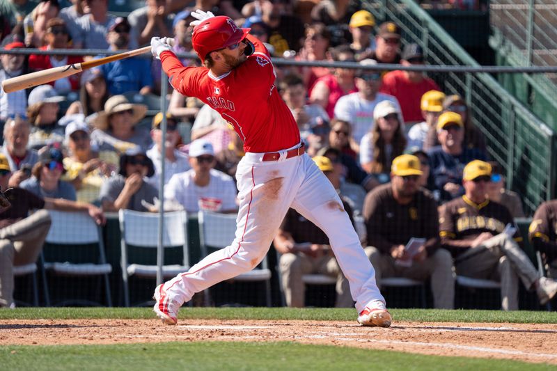 Mar 10, 2024; Tempe, Arizona, USA; Los Angeles Angels outfielder Taylor Ward (3) singles on a line drive in the sixth during a spring training game against the San Diego Padres at Tempe Diablo Stadium. Mandatory Credit: Allan Henry-USA TODAY Sports